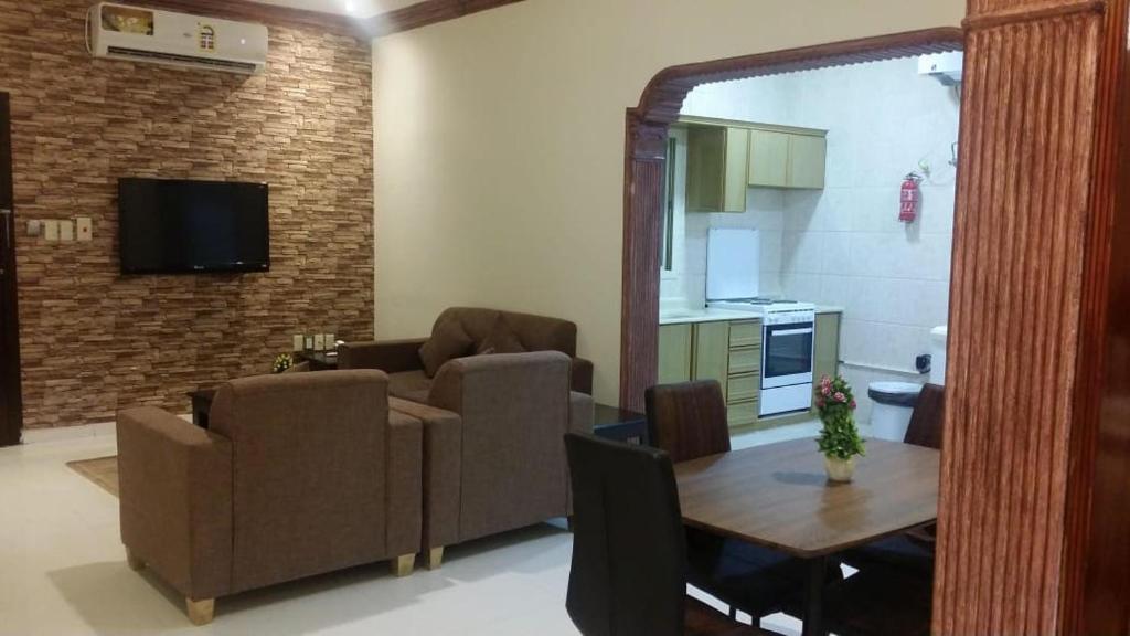 a living room with a couch and a table at Beyoot Alsharq Furnished Units in Al Khobar