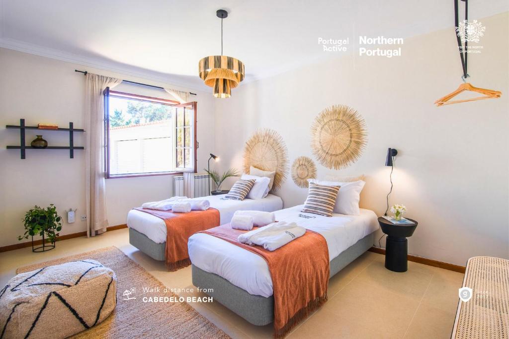 sypialnia z 2 łóżkami i oknem w obiekcie Portugal Active Cabedelo Beach Lodge - Heated Pool w mieście Viana do Castelo