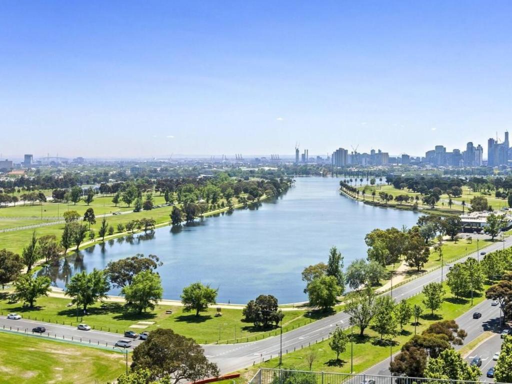 a view of a river with a city in the background at Treetop Tranquillity on Queen in Melbourne