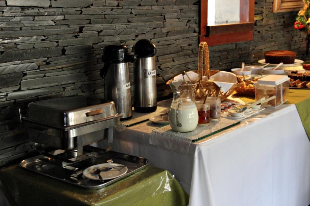 a kitchen with a coffee maker on a table at HOTEL MARAMBAIA in Guaxupé