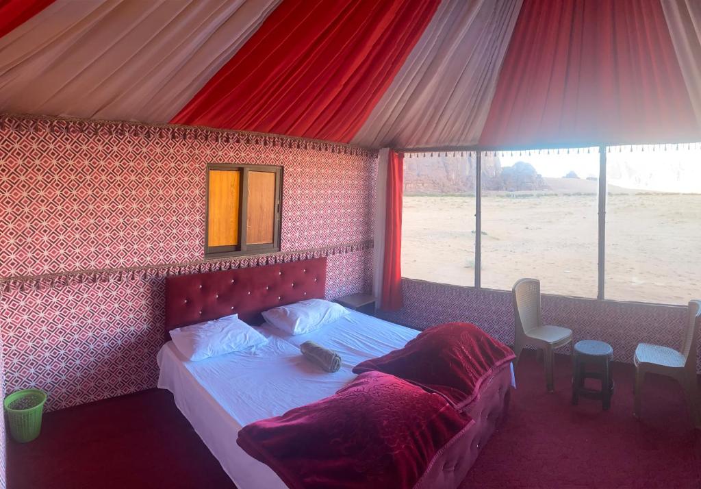 a bedroom with a bed in a tent at Wadi Rum Sights Camp in Wadi Rum