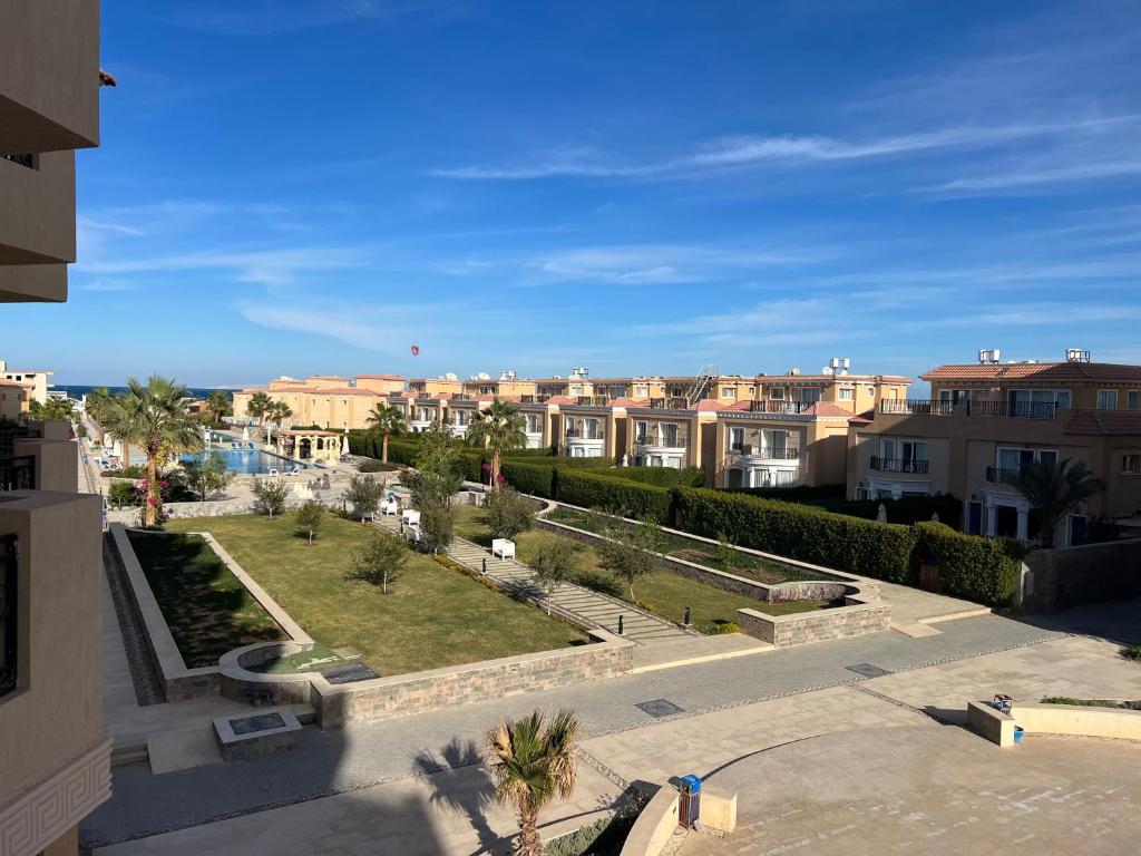 a view of a city with buildings and palm trees at Selena Bay Hurghada - Pink Apartment in Hurghada