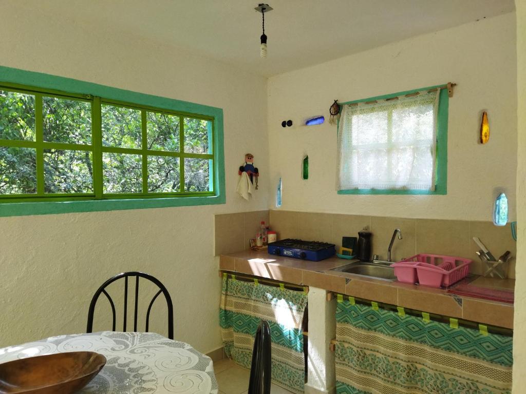 a kitchen with a sink and a counter top at Casa Ecológica in Tepoztlán