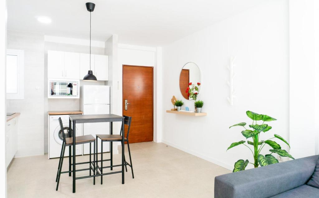 a kitchen and living room with a table and chairs at Juanito Fuengirola Apartment in Fuengirola