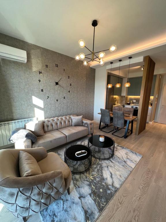 a living room with a couch and a dining room at BW Libera luxury apartment in Belgrade