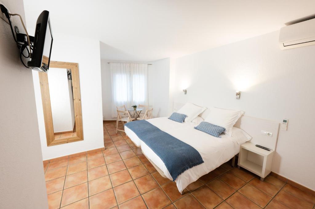 Postel nebo postele na pokoji v ubytování Hostal el Ranxo