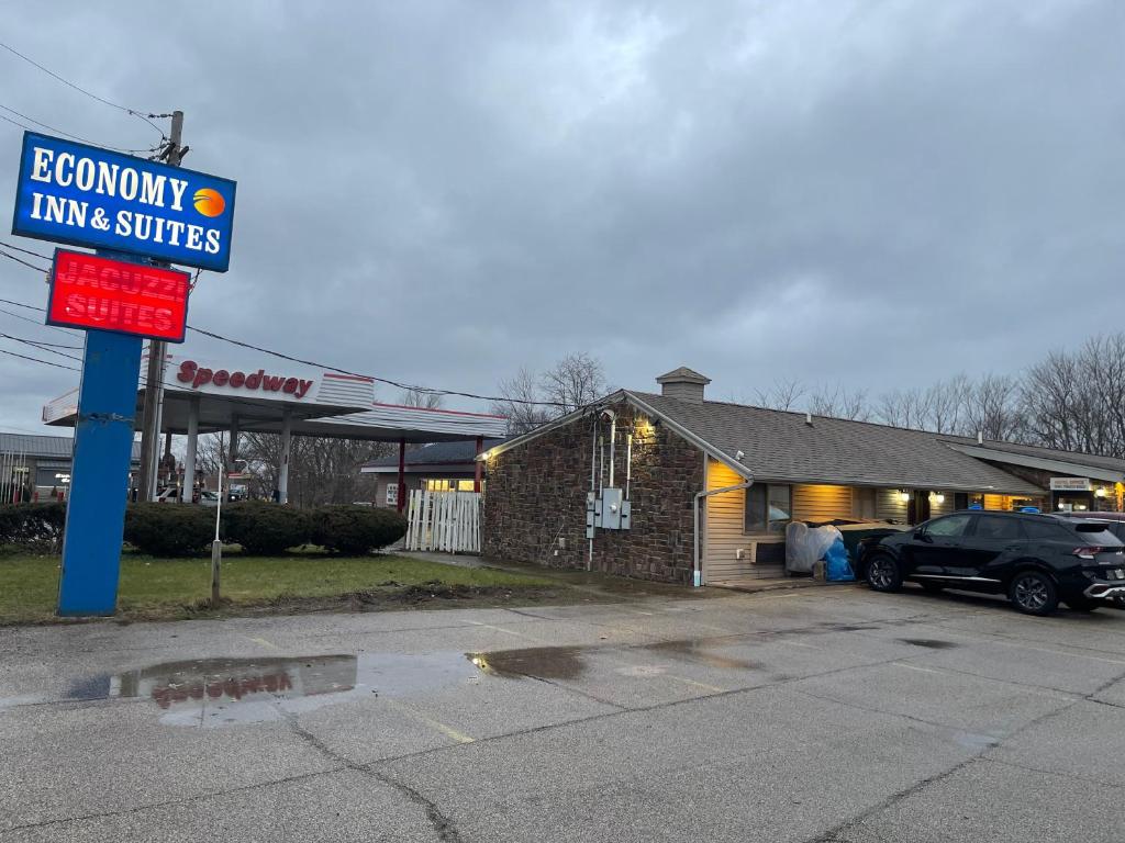 a gas station with a car parked in front of it at Economy Inn & Suites in Ashtabula