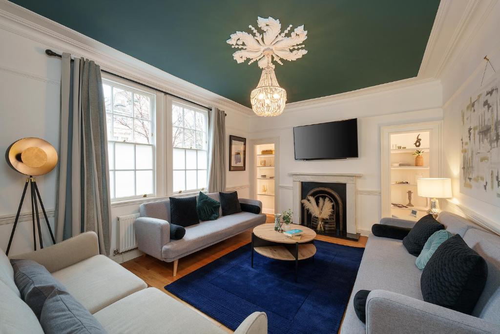 a living room with a couch and a fireplace at The Haze House - 4 Bed Townhouse in Bath