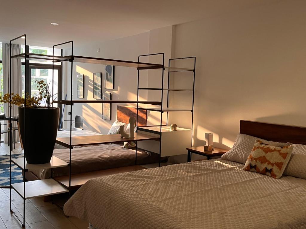 um quarto com uma cama e uma grande janela em Stylish and Cozy Apartment in Heart of Guatemala BEITA em Guatemala