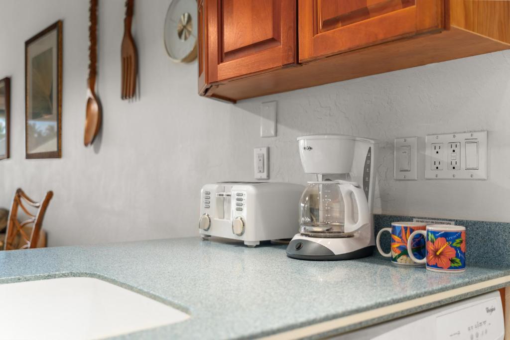 a kitchen counter with a coffee maker and a toaster at Conveniently located two bedroom two bath HK319 in Wailea