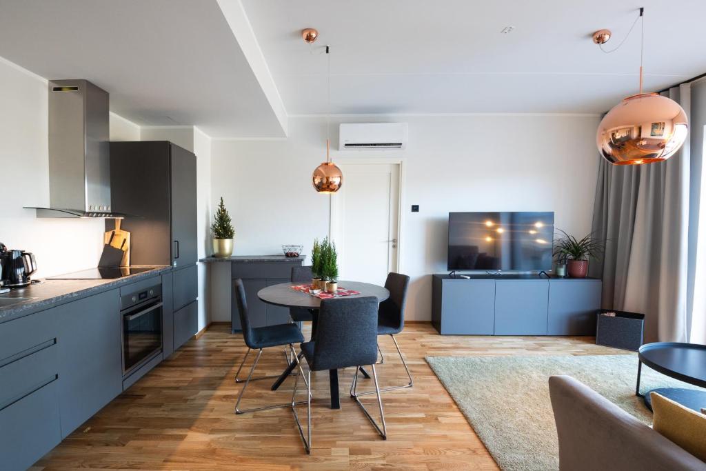 a kitchen and living room with a table and chairs at R64 Premium Apartments in Tartu