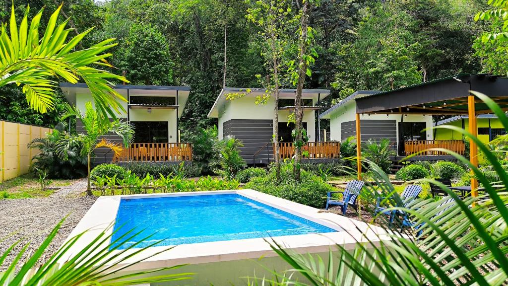 a swimming pool in front of a house at Casa Black Chaini in Puerto Viejo