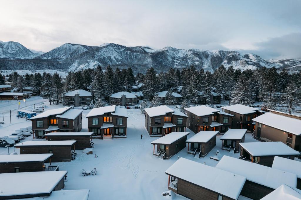 a village covered in snow with mountains in the background at Outbound Mammoth in Mammoth Lakes