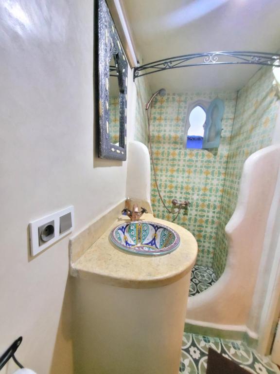 a bathroom with a sink and a shower at Honey Suckle in Chefchaouene