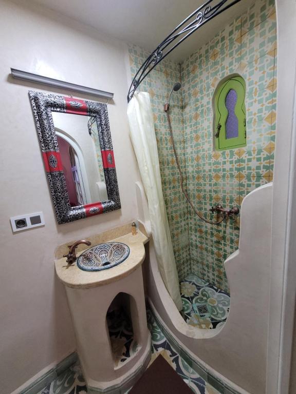 a bathroom with a sink and a shower at Honey Suckle in Chefchaouene