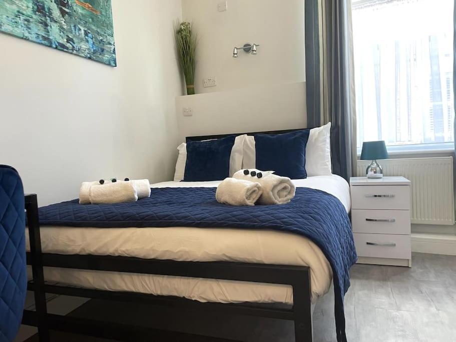 a bedroom with a bed with towels on it at The Snug - City Centre Studio in York