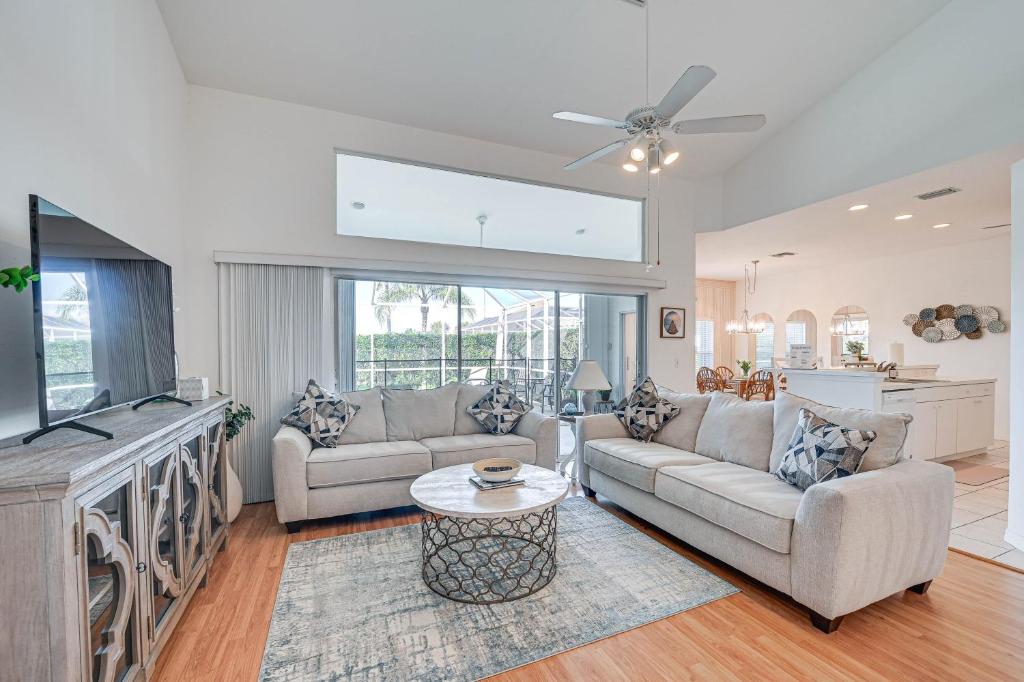 a living room with two couches and a tv at Naples Vacation Rental Home with Heated Private Pool in Naples