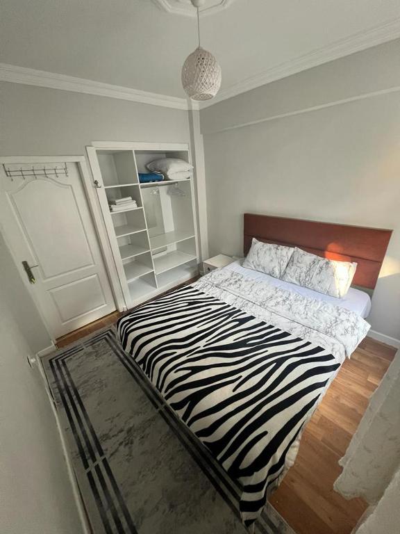 a zebra print bed in a white room with at Kadıköy Holiday Home in Istanbul