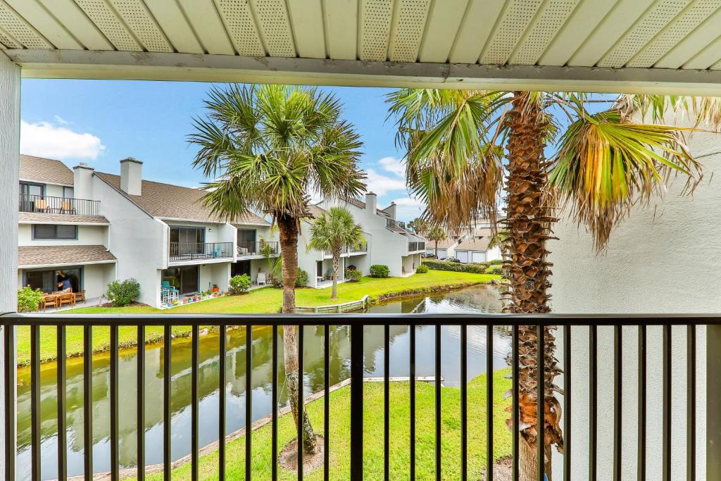 a view from the balcony of a unit with palm trees at Seawinds Oceanfront Condo in St. Augustine