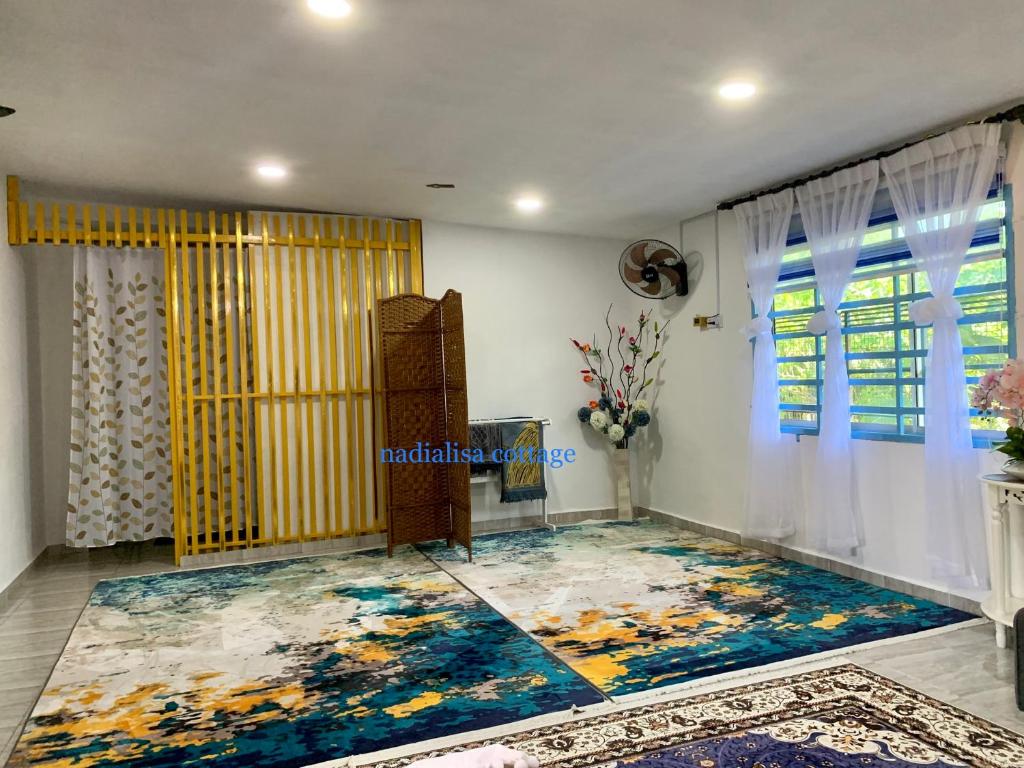 a living room with a large rug on the floor at Nadialisa cottage homestay For Islamic only in Sungai Petani