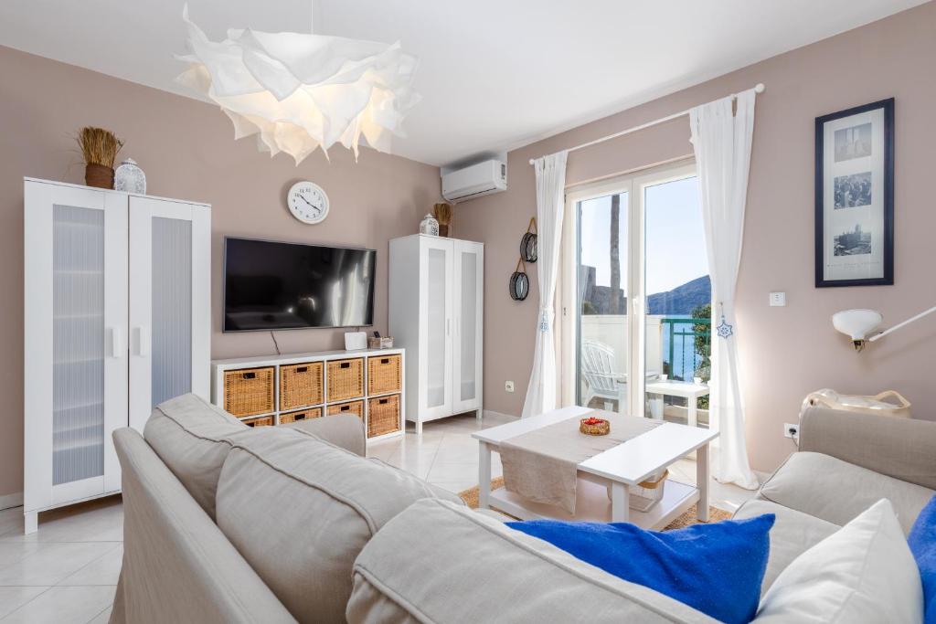 a living room with a couch and a tv at Lula la land (4 adults or family) in Herceg-Novi