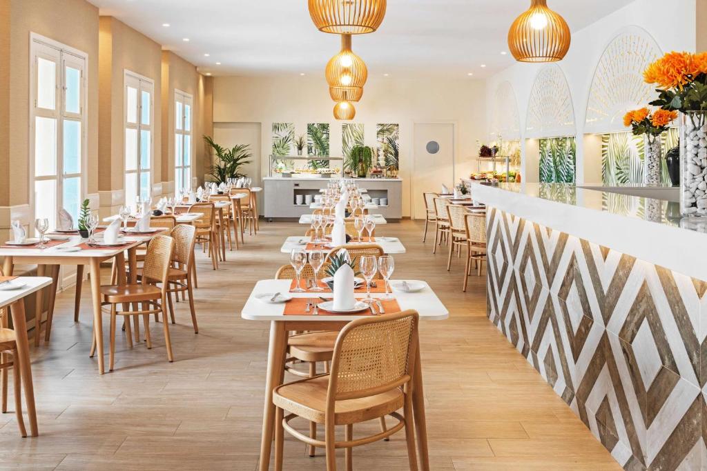 a row of tables and chairs in a restaurant at Alua Suites Fuerteventura - All Inclusive in Corralejo