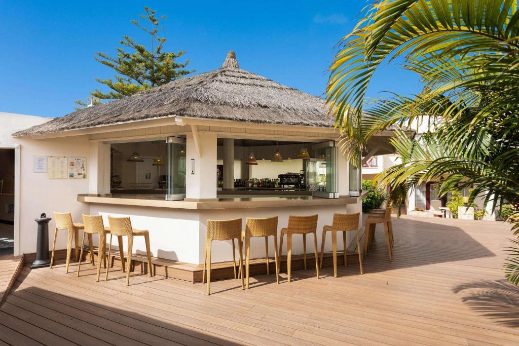 a bar on the deck of a villa at Alua Suites Fuerteventura - All Inclusive in Corralejo