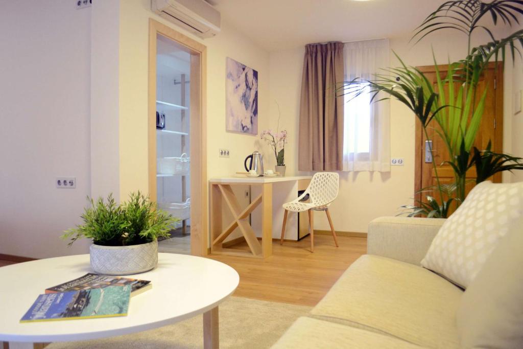 a living room with a couch and a table at Alua Suites Fuerteventura - All Inclusive in Corralejo