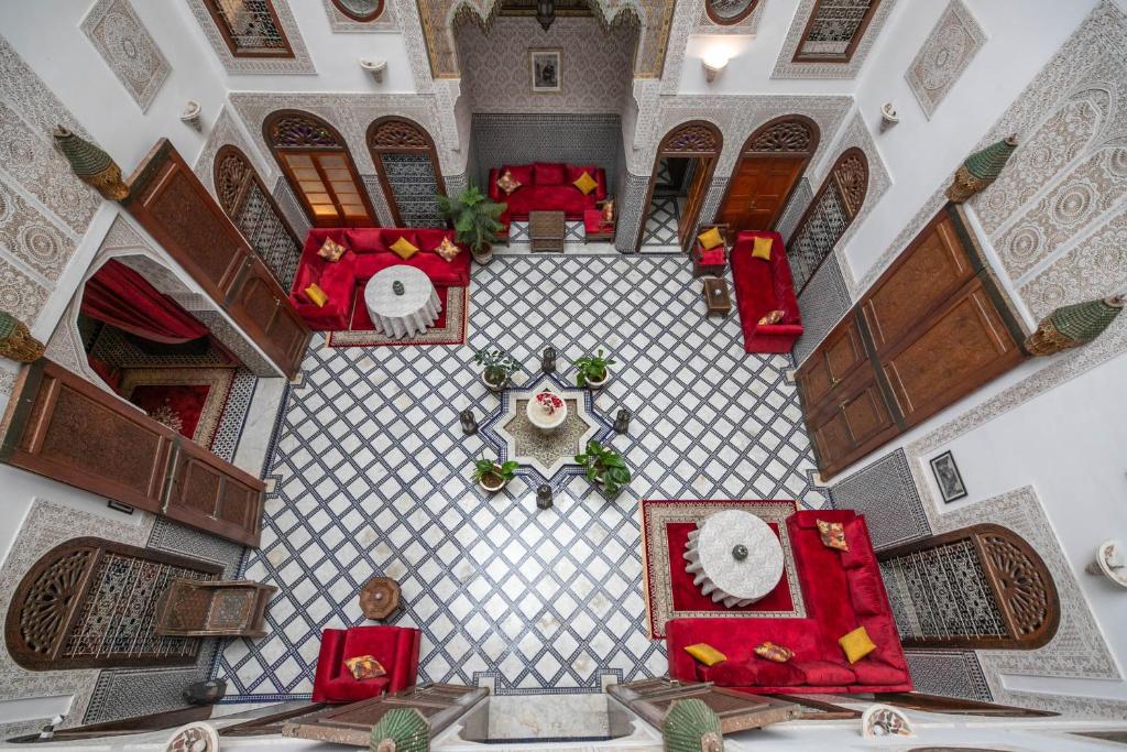 an overhead view of a living room with red furniture at La Perle de La Medina in Fès