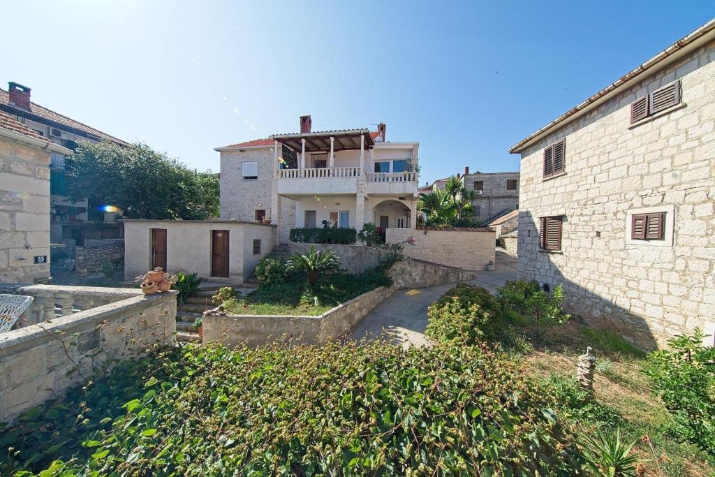 a house in the middle of a building at Apartments with a parking space Postira, Brac - 22159 in Postira