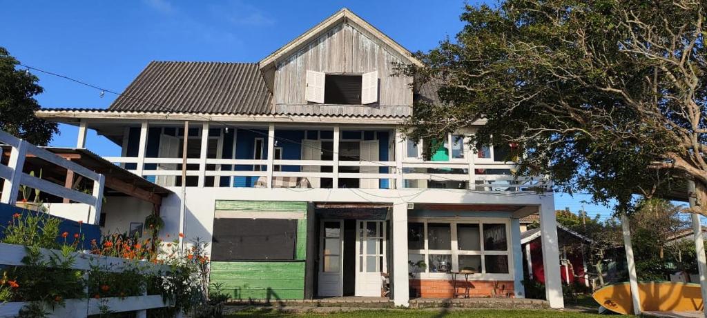 an old house with a green and white at Tambo Bombinhas in Bombinhas