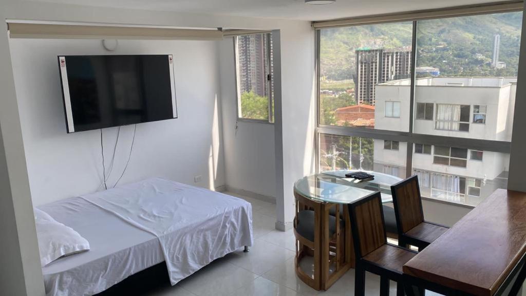 a bedroom with a bed and a tv on a wall at Bello stay in Bello