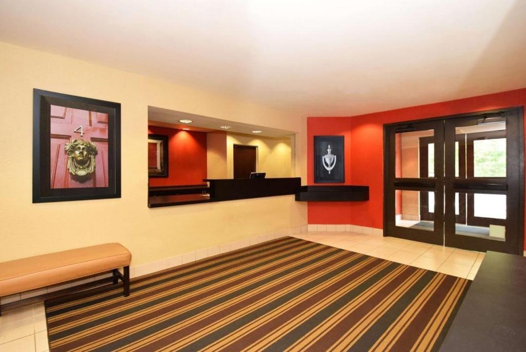 a living room with red walls and a rug at Southfield Stay in Southfield