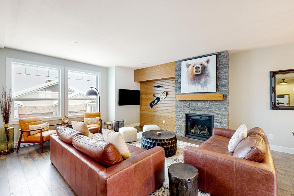 a living room with two couches and a fireplace at Bear Cave- Grizzly Ridge 260A in Big White