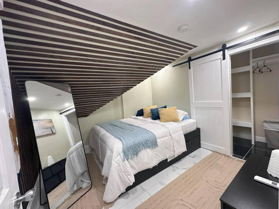 1 dormitorio con 1 cama grande y techo a rayas en Urban Life Retreat, en Providence