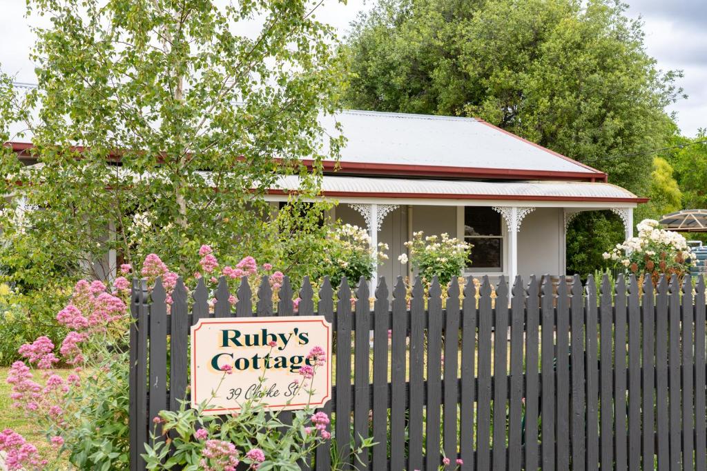 a sign on a fence in front of a house at Ruby's Cottage in Penola