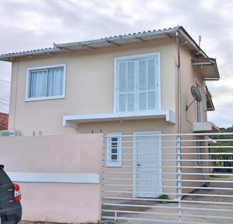 a house with stairs in front of it at Apto nos Ingleses in Florianópolis