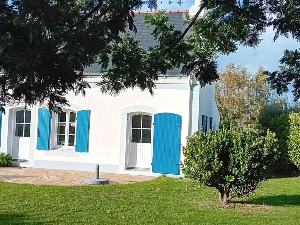 a white and blue house with blue shutters at Maison Le Palais, 4 pièces, 6 personnes - FR-1-418-234 in Le Palais