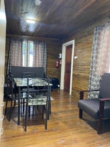 a dining room with a table and chairs at Camp Taveuni in Matei