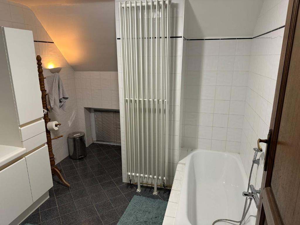 a bathroom with a white tub and a shower at Ferme d’Herlaimont in Chapelle-lez-Herlaimont