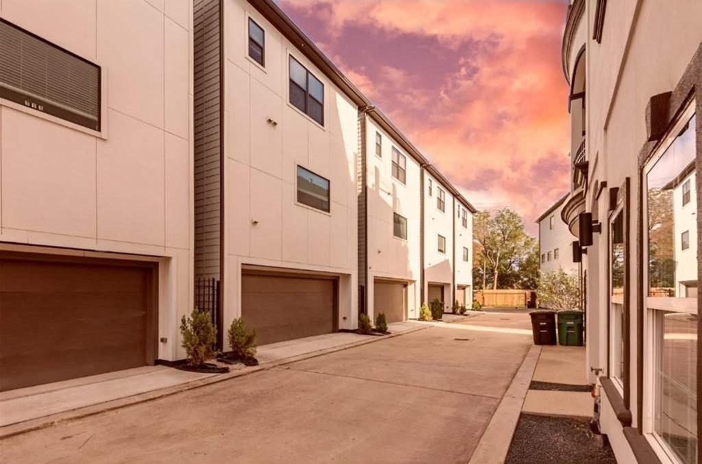 an empty street with two garage buildings at Downtown Houston Haven in Houston