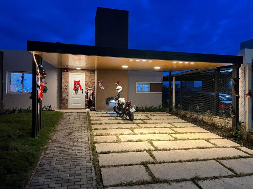 a motorcycle parked in front of a house at night at Reserva Tajamar in Alta Gracia