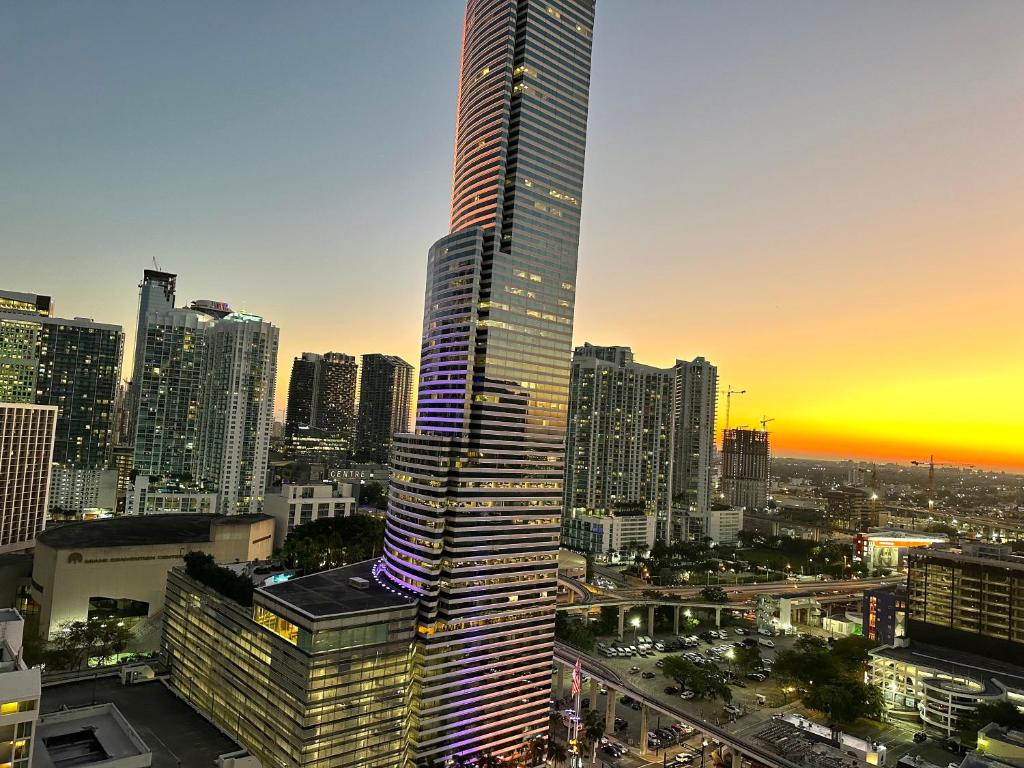 un rascacielos alto en una gran ciudad al atardecer en Pool Rooftop Luxury loft Miami Downtown, Brickell, en Miami