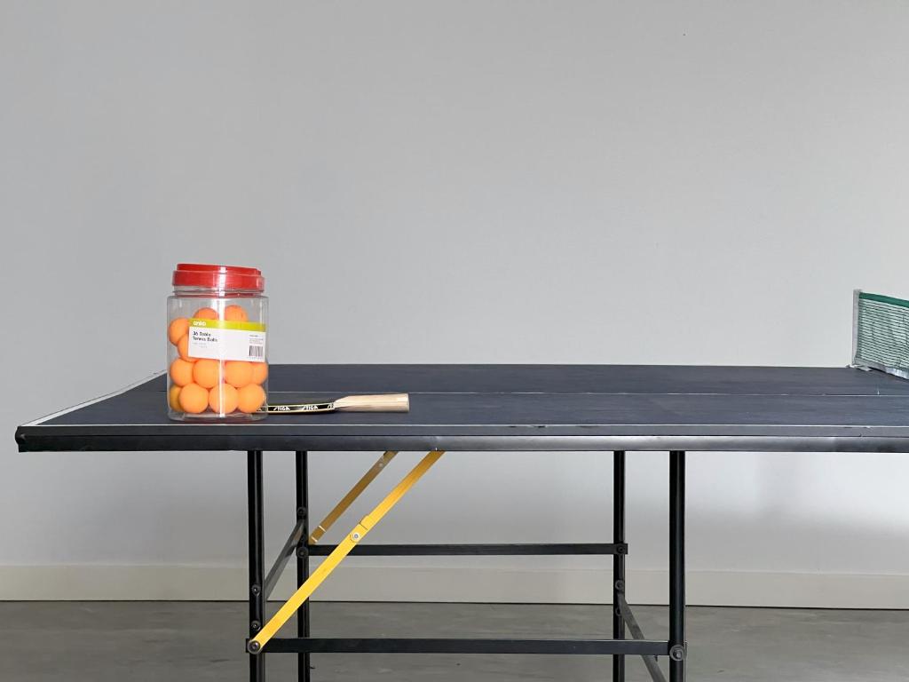 a table with a jar of oranges and a knife at Rosebud Lovely House 2 - Mornington Peninsula 4 BR 3 Bath 2 story holiday house - BBQ - Beach - Hot spring in Rosebud