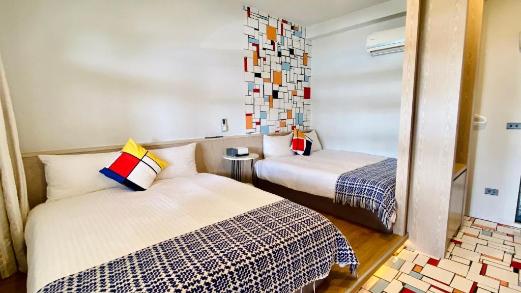 a bedroom with two beds and a mirror at Mini Summer in Nanwan