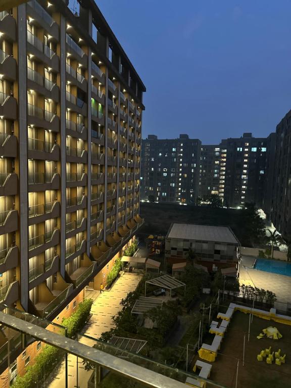 a view of a building with a parking lot at Weekend Address in Surat