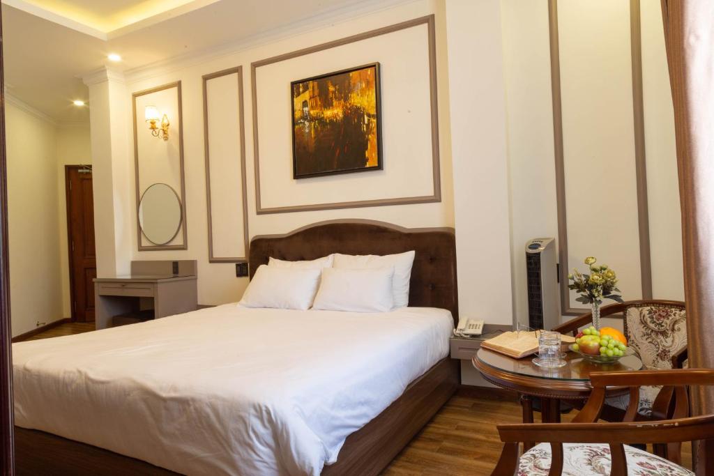Postel nebo postele na pokoji v ubytování Win Hotel Đà Lạt
