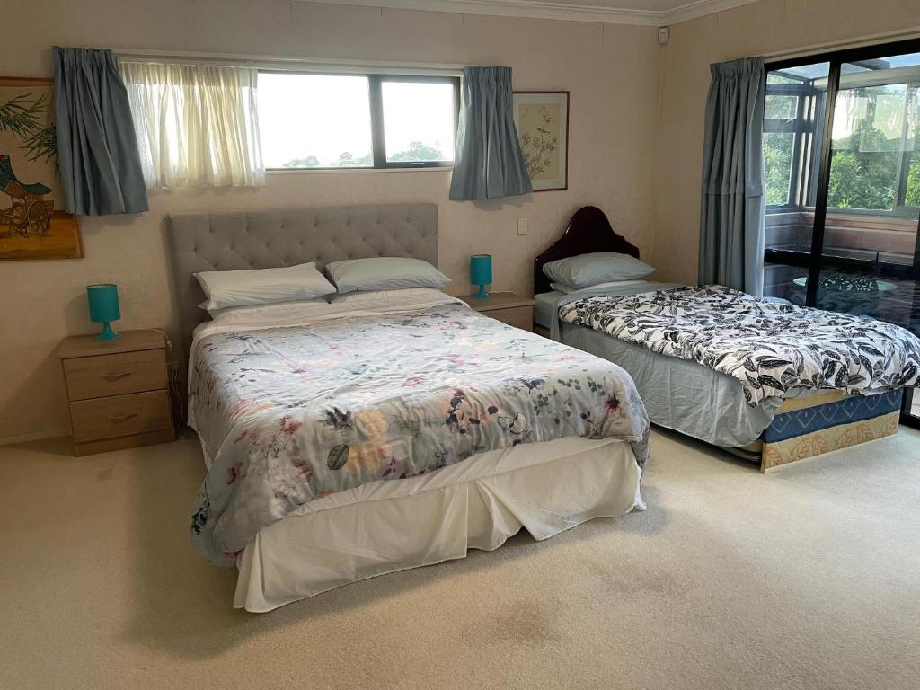 a bedroom with two beds and a window at Rooms in Epsom House in Auckland