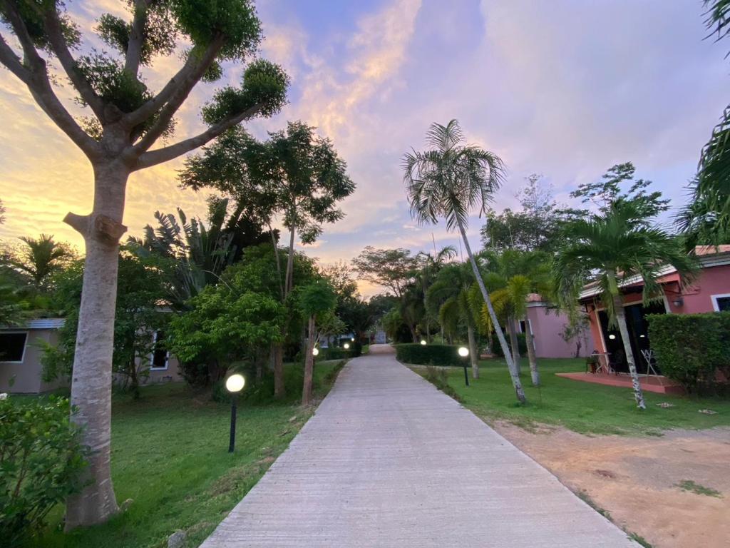 a sidewalk with palm trees and street lights in a park at Green Tree Cottage in Klong Muang Beach