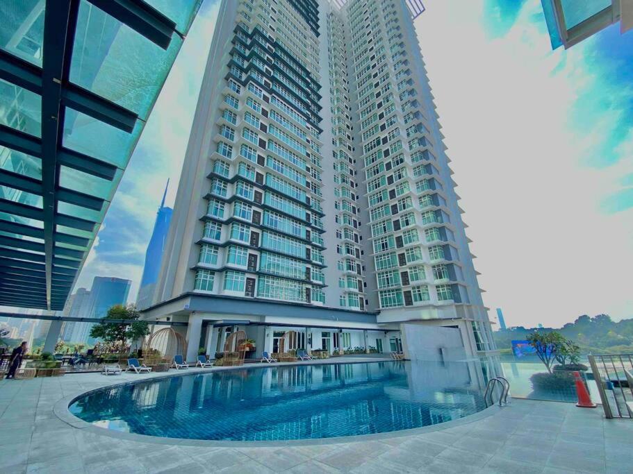 a large building with a swimming pool in front of it at KL Q520 Premium Suite Room in Kuala Lumpur